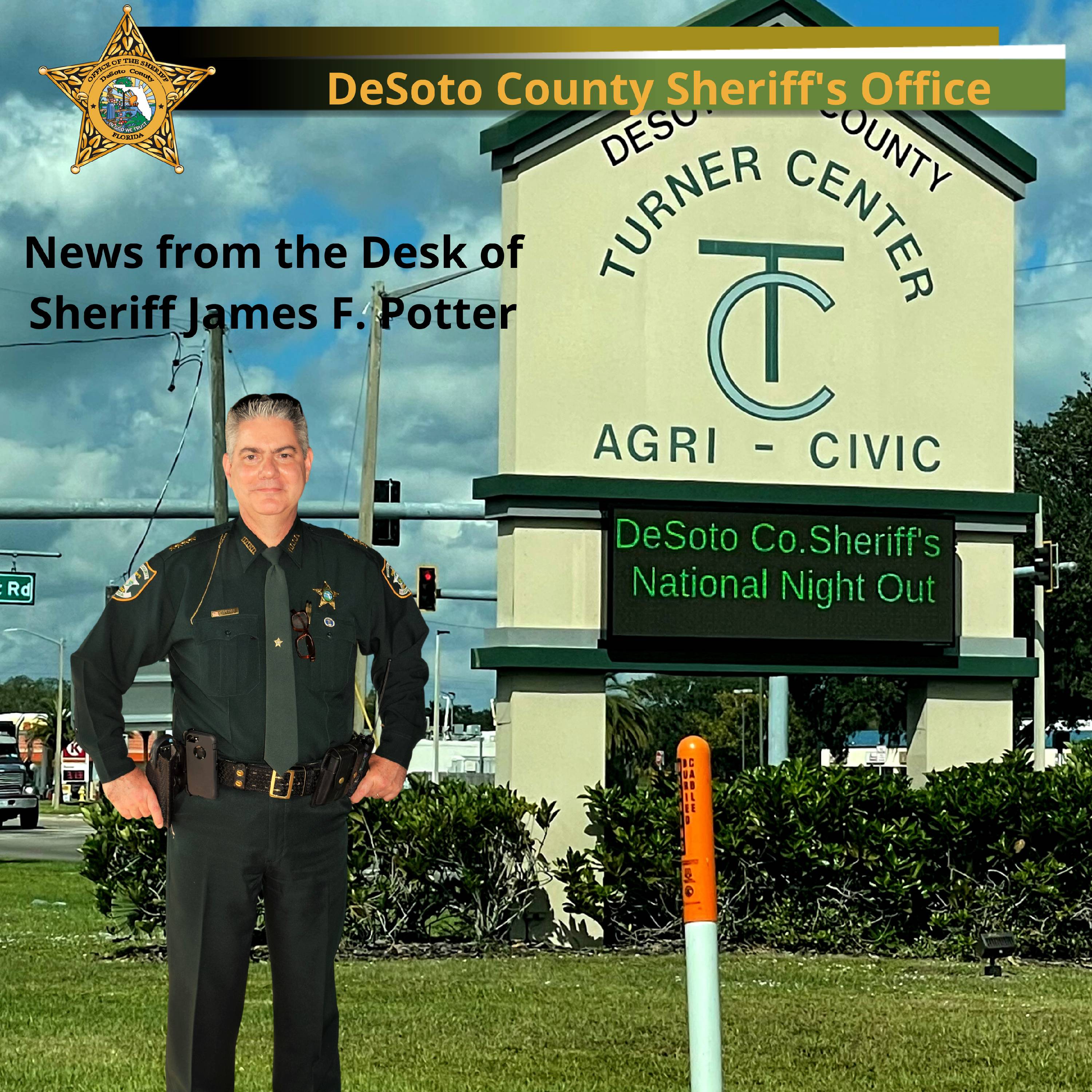 Sheriff Potter standing in front of the Turner Center message board reading DeSoto County Sheriff's Office National Night Out - Copy